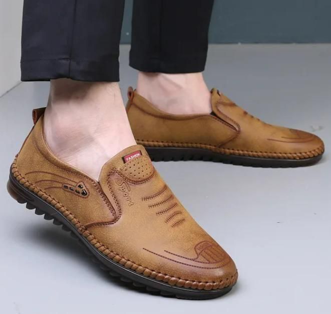 Men's leather shoes in brown color, slip-on style with detailed stitching and PU sole, perfect for casual wear.
