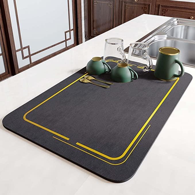 Lightweight quick-drying mat on kitchen countertop with dishes and glasses, featuring a stylish design and rubber backing.
